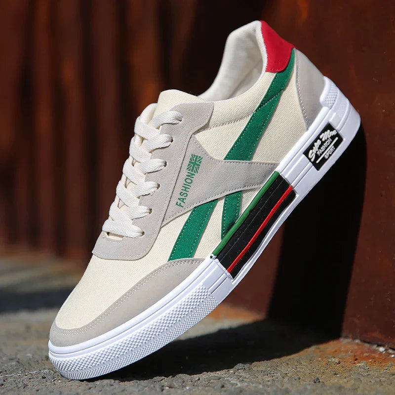 Beige and green canvas streetwear sneaker with white sole and red accent, low-top fit.
