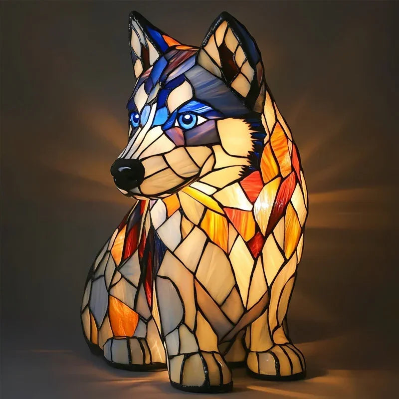 Stained glass wolf lamp with blue, amber, and cream mosaic design, illuminated indoors