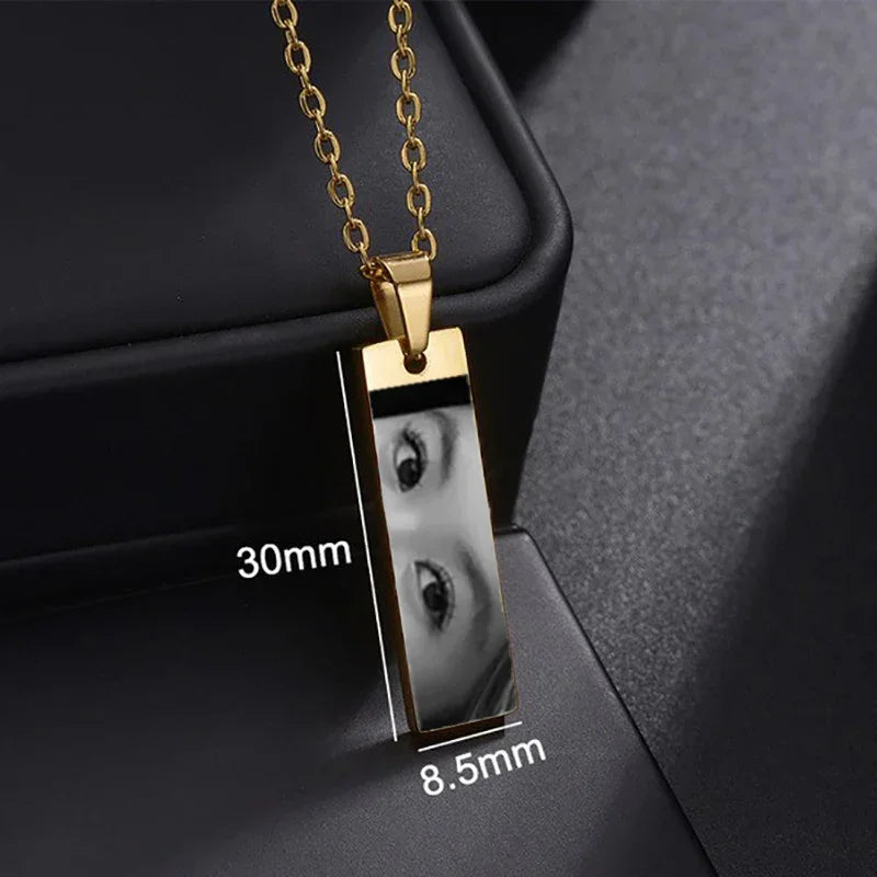 Gold rectangular photo pendant necklace, reflective surface, modern minimalist jewelry
