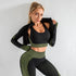Woman wearing black and green textured seamless activewear set with body-hugging fit