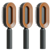Three modern oval hair brushes with brown and black handles, sleek minimalist design