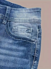 Close-up of blue denim jeans with a faded wash, visible stitching, and front pocket detail