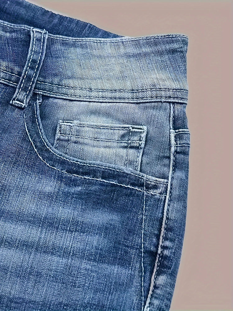 Close-up of blue denim jeans with a faded wash, visible stitching, and front pocket detail