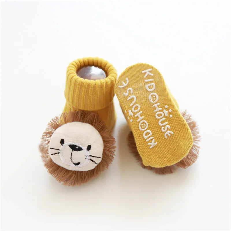 Yellow knit baby booties with plush lion face and non-slip sole, soft and cozy fit