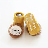 Yellow knit baby booties with plush lion face and non-slip sole, soft and cozy fit