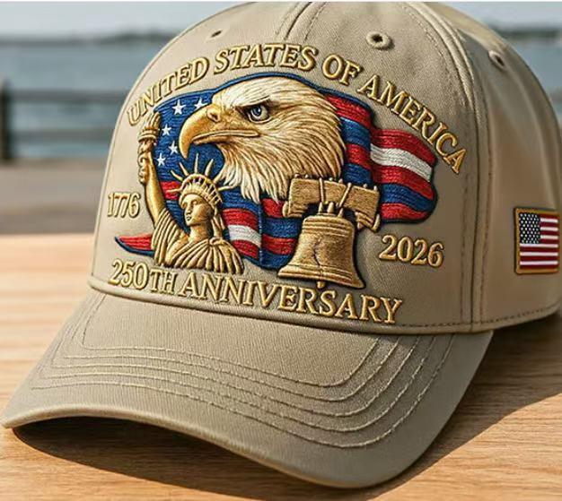Khaki baseball cap with detailed embroidered eagle, Liberty Bell, Statue of Liberty, and USA flag, structured fit.