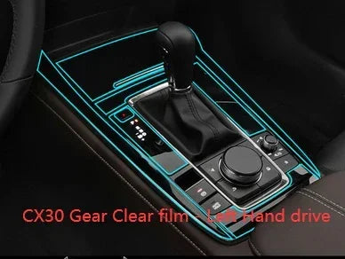 Black leather gear shift panel with clear film protection for left hand drive vehicle interior.