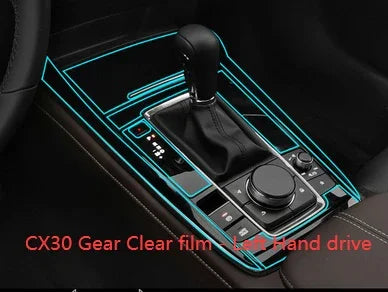 Black leather gear shift panel with clear film protection for left hand drive vehicle interior.