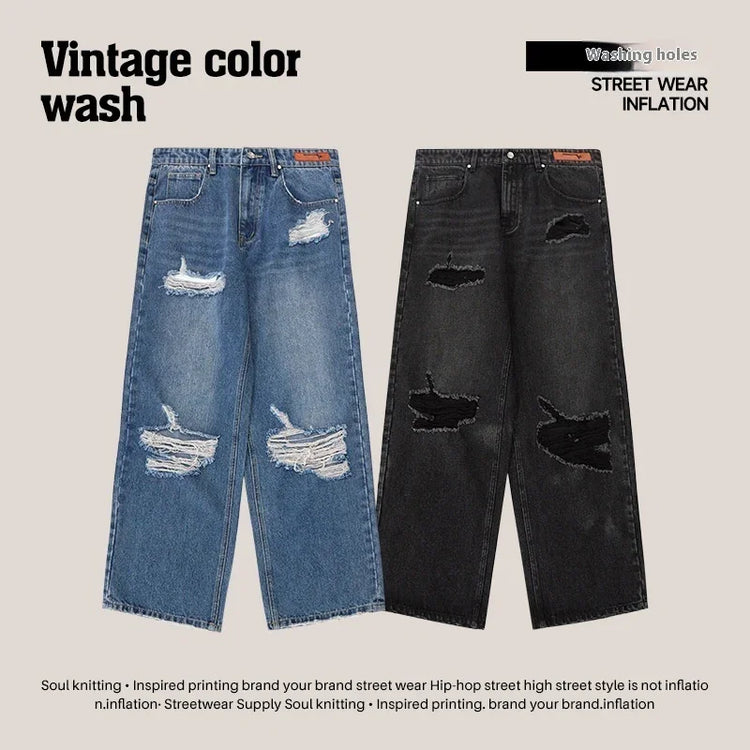 Loose fit distressed blue and black jeans with ripped details, vintage wash streetwear style.
