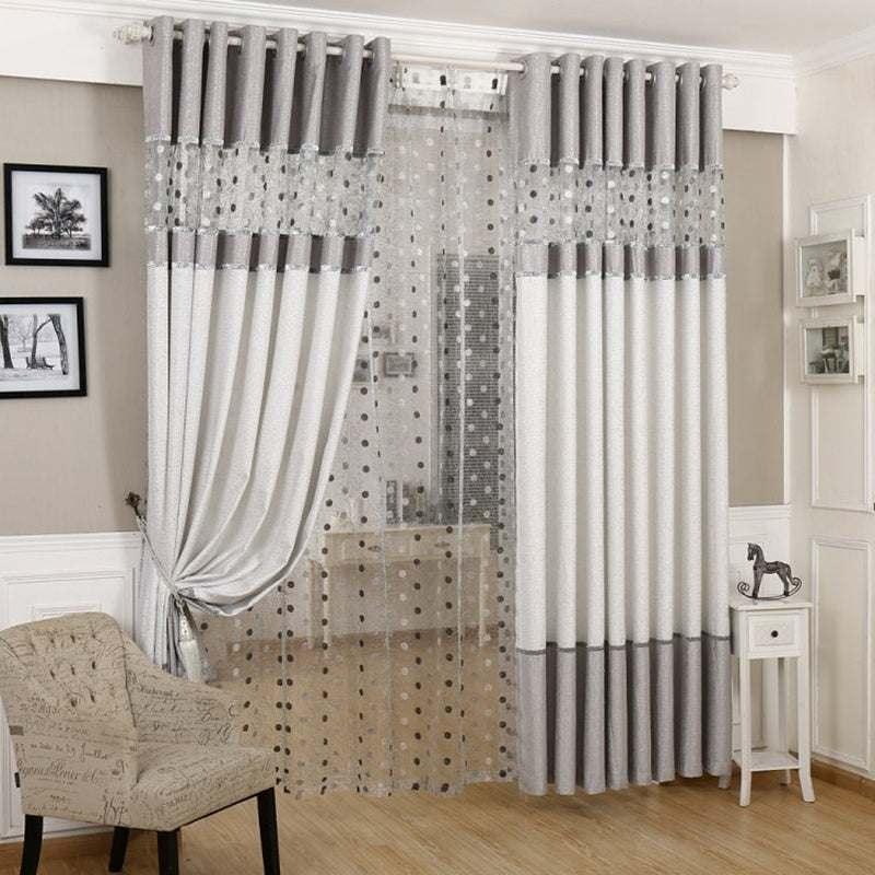 Gray and white blackout curtains with sheer polka dot panel in a modern living room