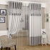 Modern living room with gray and white blackout curtains and sheer polka dot panel.