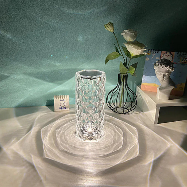 Crystal clear geometric glass vase reflecting light on tabletop, minimal modern decor