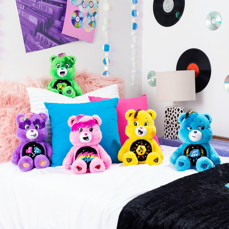 Care Bears Rock-a-Lot plush collection featuring 14" colorful bears with musical belly badges in a bedroom setting