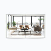 Open book showing modern living room design with large windows and neutral furniture from The Art of Home by Shea McGee