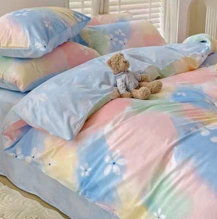 Pastel tie-dye bedding set with soft blue, pink, and yellow colors, smooth material, relaxed fit.