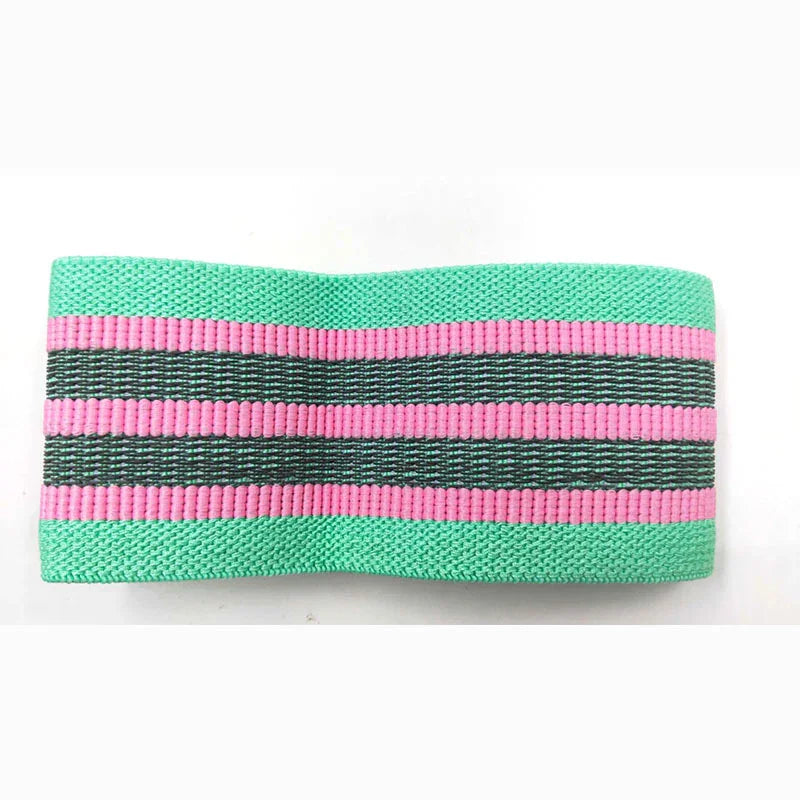 Wide elastic headband in mint green with pink and black stripes, textured fabric