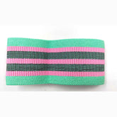 Wide elastic headband in mint green with pink and black stripes, textured fabric