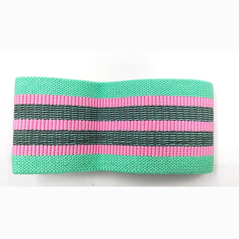 Wide elastic headband in mint green with pink and black stripes, textured fabric