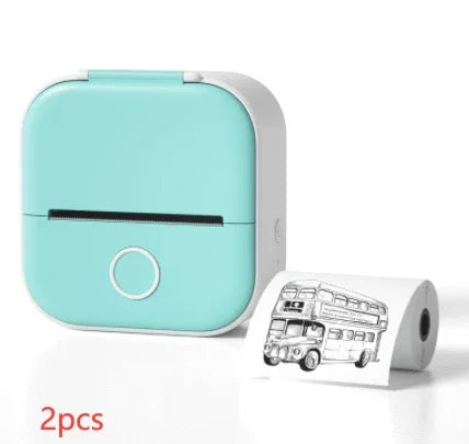 Compact mint green mini thermal printer with roll of printed paper, tech lifestyle accessory