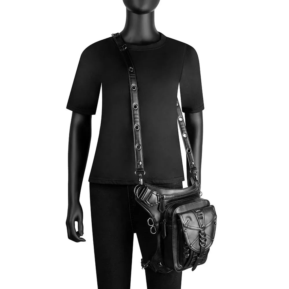 Black short sleeve t-shirt and fitted pants styled with a black faux leather utility bag.