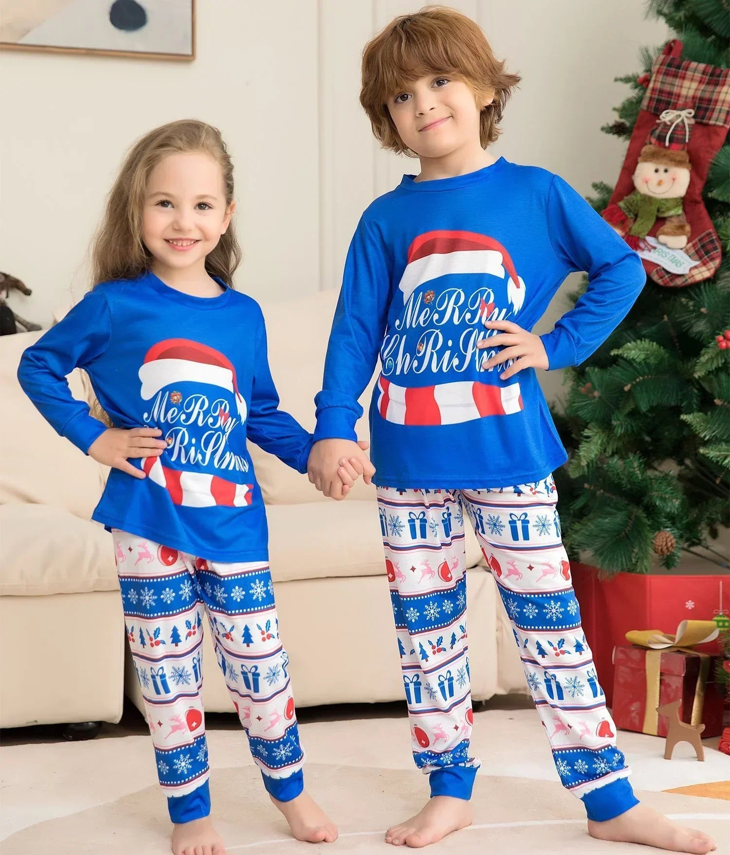 Kids in blue Christmas pajama sets with printed holiday patterns and relaxed fit.