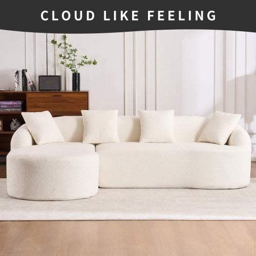 Plush white boucle sofa with rounded chaise and four matching pillows in modern living room
