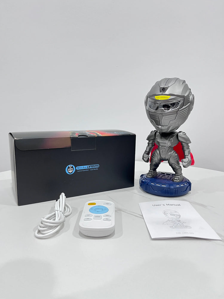 Silver and red robot toy with helmet, remote control, user manual, and box on white table