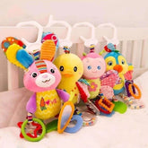 Colorful plush animal toys with rings and soft fabric, hanging on crib rail