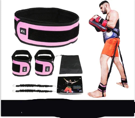Man wearing orange shorts and black athletic gear with pink trim, demonstrating resistance bands and cuffs, fitness accessory set displayed on white background.