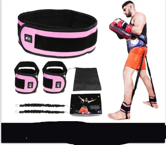 Man wearing orange shorts and black athletic gear with pink trim, demonstrating resistance bands and cuffs, fitness accessory set displayed on white background.