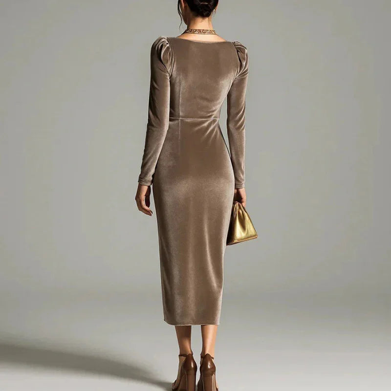 Woman wearing a fitted taupe velvet long sleeve midi dress with puff shoulders