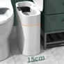 Slim white plastic bathroom trash can with lid, narrow fit beside toilet, 15cm wide.