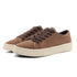 Brown suede low-top sneakers with thick white rubber soles and round toes