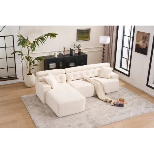 Modern cream sectional sofa with plush cushions and soft fabric, chaise lounge design, in contemporary living room