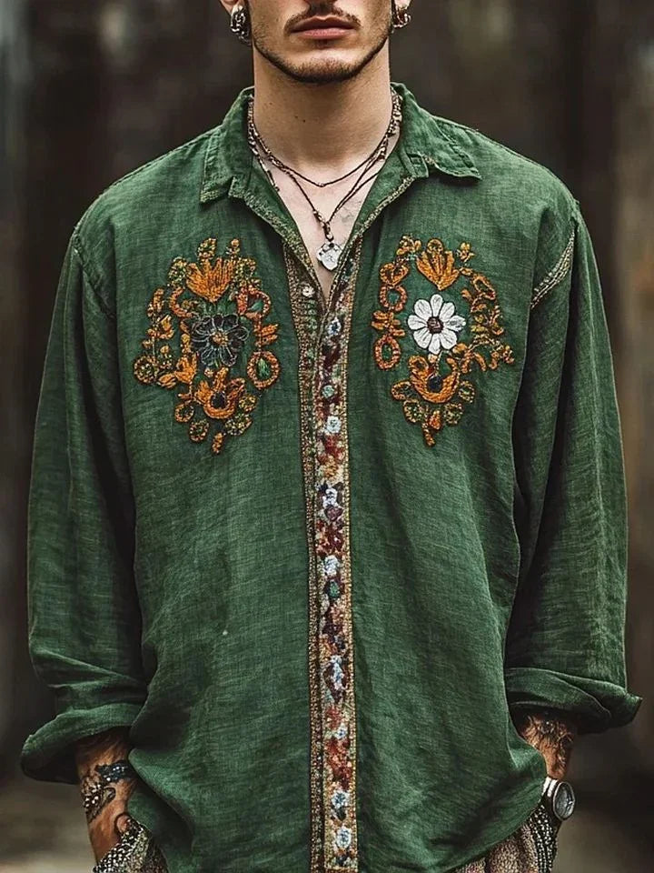 Man wearing loose fit green linen shirt with colorful floral embroidery and button details