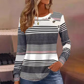 Woman wearing a long sleeve striped pullover in black, white, and gray with relaxed fit