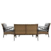 Three-piece brown wicker patio furniture set with black metal frames and gray cushions