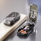 Sleek black pill organizer case with clear lid, mirror, and multiple compartments for tablets
