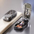 Sleek black pill organizer case with clear lid, mirror, and multiple compartments for tablets