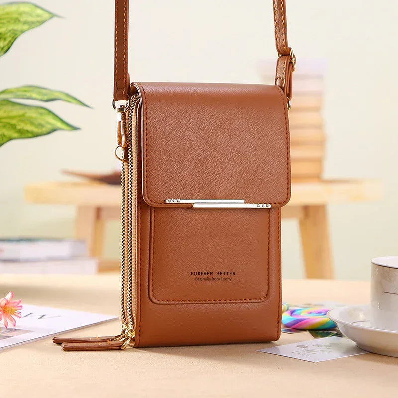 Brown leather crossbody bag with gold zipper, slim modern design, adjustable strap, structured fit