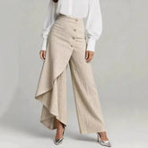Beige wide-leg high-waist pants with pleated textured fabric and asymmetrical drape detail