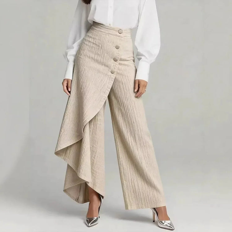 Beige wide-leg high-waist pants with pleated textured fabric and asymmetrical drape detail