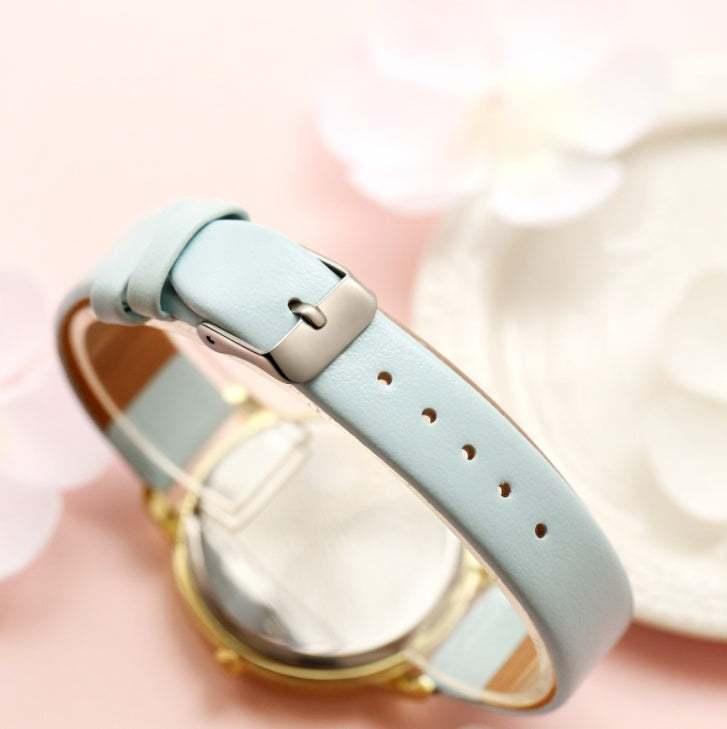 Light blue leather watch strap with silver buckle, soft finish, adjustable fit