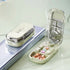Compact pill organizer in glossy beige plastic with multiple compartments, filled with tablets.