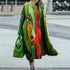 Woman wearing colorful oversized streetwear coat with abstract face print, bold colors, loose fit