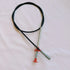 Black cable necklace with silver metal accents and red end caps on neutral background