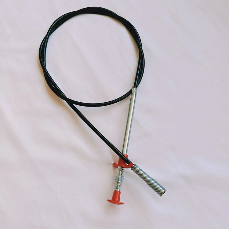 Black cable necklace with silver metal accents and red end caps on neutral background