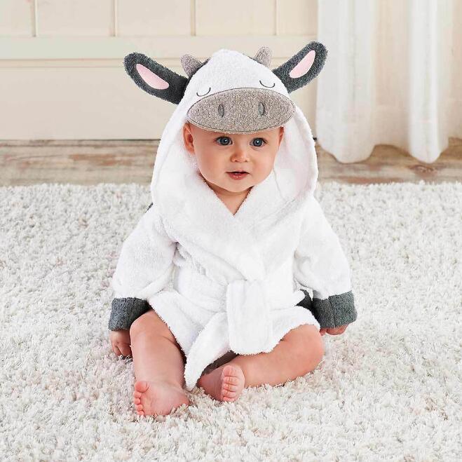 Baby in white hooded robe with animal ear and face design, plush material, relaxed fit