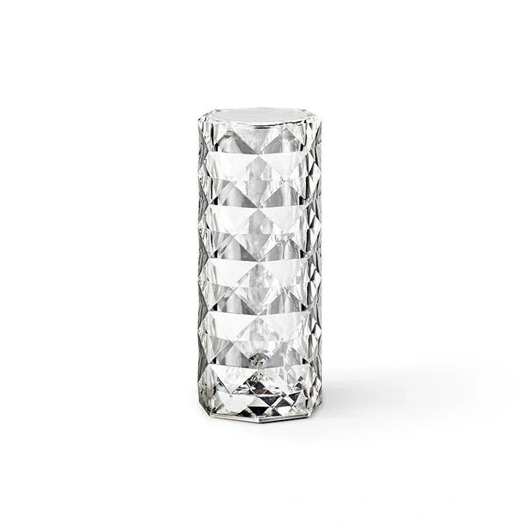 Clear geometric faceted glass tumbler on a white background