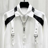 White long sleeve shirt with black faux leather shoulder accents and metal buckle details, modern streetwear style